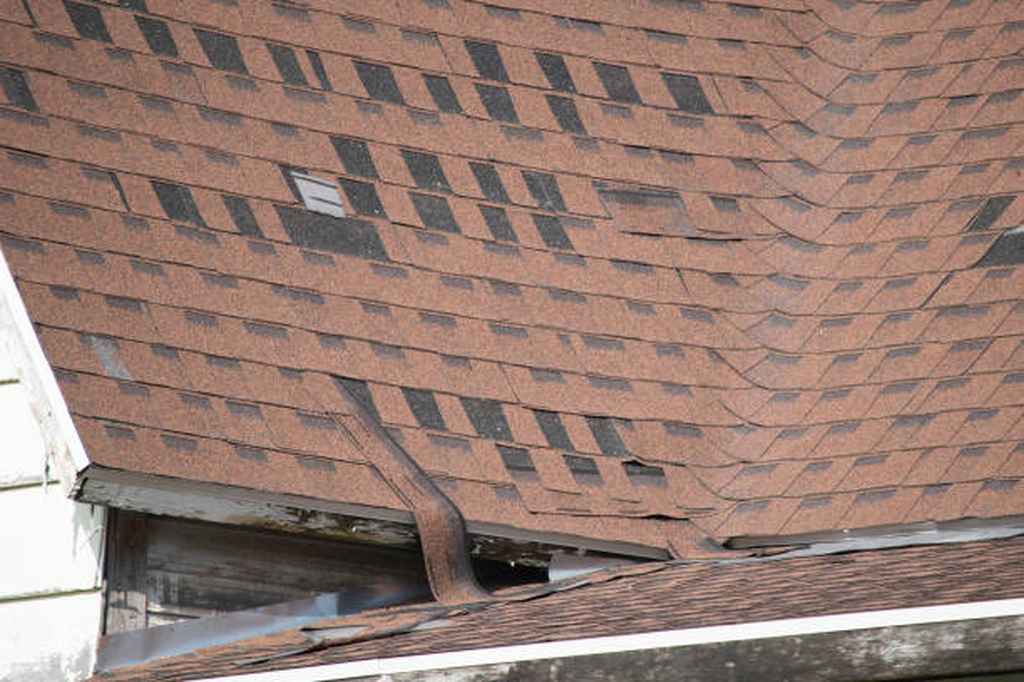 damaged asphalt shingle roofing due to strong wind Franklin, TN