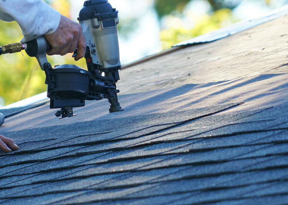 Professional roofing contractor replacing an old residential roof in Franklin, TN